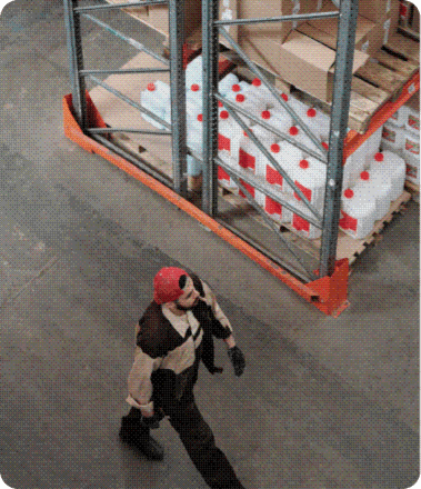 A warehouse worker walking past racking