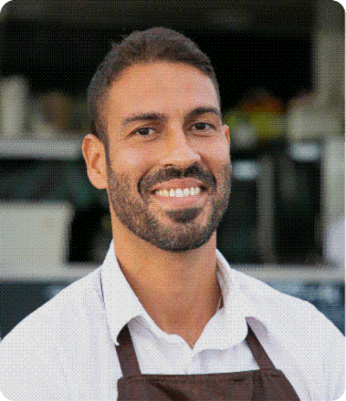 A smiling business owner in their shop