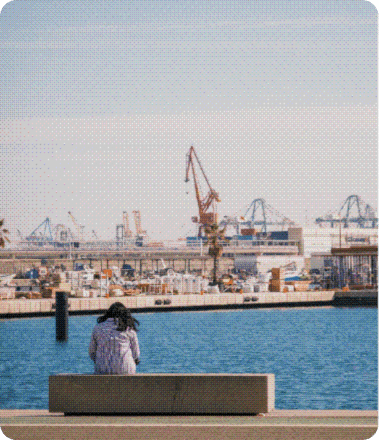 A person sitting by the harbour
